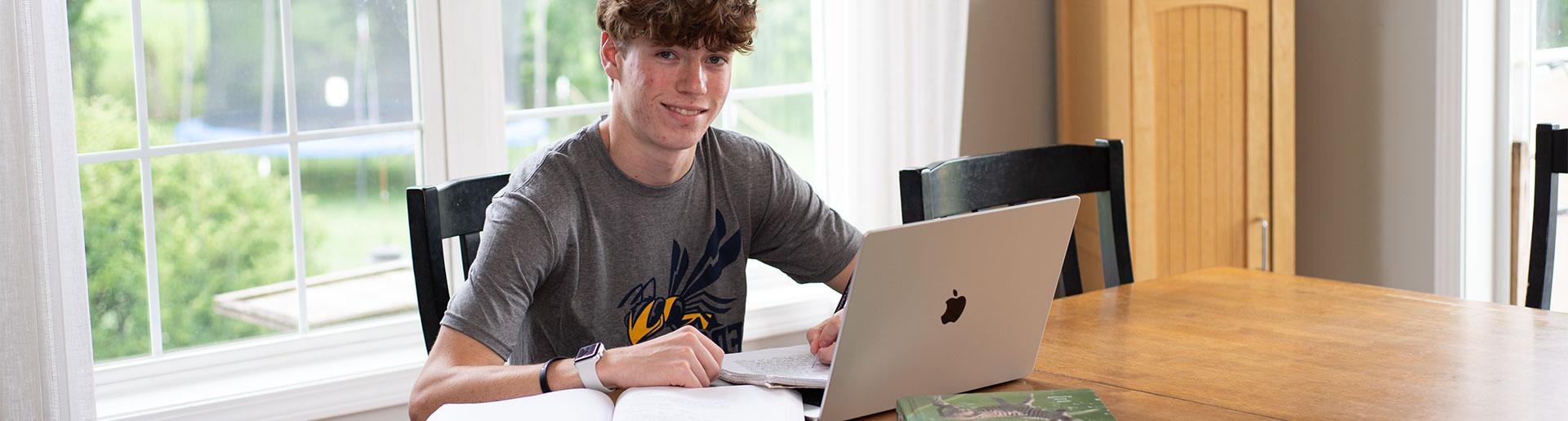 High school student studying at table